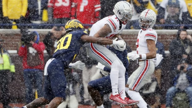 Ohio State Buckeyes wide receiver Jaxon Smith-Njigba (11) makes a catch against Michigan Wolverines defensive back Daxton Hill (30) during the first quarter of their NCAA College football at Michigan Stadium at Ann Arbor, Mi on November 27, 2021. Osu21um Kwr 14